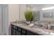 Double vanity bathroom with granite countertop and large mirror at 1200 Aloha Blvd, Davenport, FL 33897