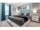 King bedroom with teal and gray color scheme, and modern decor at 1200 Aloha Blvd, Davenport, FL 33897