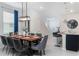 Dining room with large wooden table, gray chairs, and modern lighting at 1200 Aloha Blvd, Davenport, FL 33897