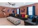 Game room with sectional sofa, ottoman and super hero decor at 1200 Aloha Blvd, Davenport, FL 33897