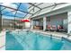 Inviting swimming pool with covered patio and comfortable seating area at 1200 Aloha Blvd, Davenport, FL 33897