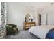 Bedroom with mid-century modern furniture and green accent chair at 1216 White Ash Loop, Deland, FL 32720