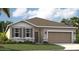 One-story home with a two-car garage and landscaping at 1216 White Ash Loop, Deland, FL 32720