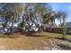 Spacious backyard with mature oak trees and wooden fence at 1325 Paperwoods Dr, St Cloud, FL 34772