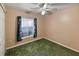 Bedroom with window, ceiling fan, and green carpet at 1325 Paperwoods Dr, St Cloud, FL 34772