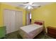 Bedroom with double bed, ample closet space, and ceiling fan at 1325 Paperwoods Dr, St Cloud, FL 34772