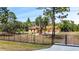 Single-story home with red tile roof and gated entrance at 13305 Lacebark Pine Rd, Orlando, FL 32832