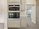 Built-in double oven and gray cabinets in this modern kitchen at 13305 Lacebark Pine Rd, Orlando, FL 32832