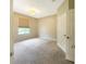 Cozy bedroom featuring neutral walls, carpet flooring, and window bringing in natural light at 13536 Turtle Marsh Loop # 538, Orlando, FL 32837
