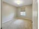 A carpeted bedroom featuring a large window with natural light at 13536 Turtle Marsh Loop # 538, Orlando, FL 32837