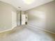 An unfurnished bedroom with multiple closets, neutral carpeting, and an open doorway at 13536 Turtle Marsh Loop # 538, Orlando, FL 32837