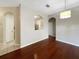 Dining room with gleaming wood floors and unique archway feature into the kitchen at 13536 Turtle Marsh Loop # 538, Orlando, FL 32837