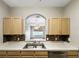 A kitchen sink and countertop view shows the pass-through into the living room at 13536 Turtle Marsh Loop # 538, Orlando, FL 32837