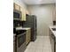 Efficient kitchen features stainless steel appliances, light wood cabinets, and tiled floor at 13536 Turtle Marsh Loop # 538, Orlando, FL 32837