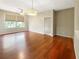 Spacious living room features gleaming wood floors, natural light, and modern ceiling fan at 13536 Turtle Marsh Loop # 538, Orlando, FL 32837