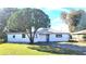 White single story home with a large tree in the front yard at 1416 Wilton Ave, Orlando, FL 32805