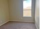 Simple bedroom with carpeted floors and large window at 14515 Huntcliff Park Way, Orlando, FL 32824