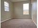 Bright bedroom featuring carpeted floors and two windows at 14515 Huntcliff Park Way, Orlando, FL 32824