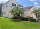 Two-story house with a landscaped yard and palm trees at 14515 Huntcliff Park Way, Orlando, FL 32824