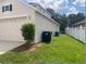 Exterior side view, showing a garage and fenced yard at 14515 Huntcliff Park Way, Orlando, FL 32824