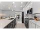 Modern kitchen with white cabinets, quartz countertops, and stainless steel appliances at 14742 Masthead Landing Cir, Winter Garden, FL 34787