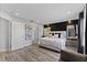 Main bedroom with king bed, gray accent chair, and wood floors at 14742 Masthead Landing Cir, Winter Garden, FL 34787