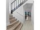 Modern staircase with dark wood railing and light wood steps at 14742 Masthead Landing Cir, Winter Garden, FL 34787