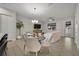 Open dining area with chandelier and adjacent living room and kitchen at 1479 Brookdale Ct, Oviedo, FL 32765