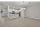 Open dining area with chandelier and adjacent living room and kitchen at 1479 Brookdale Ct, Oviedo, FL 32765