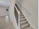 Modern staircase with metal railing and carpet runner at 1479 Brookdale Ct, Oviedo, FL 32765