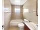 Bathroom with tiled walls, shower-tub and modern vanity at 14912 Sw 35Th Cir, Ocala, FL 34473