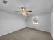 A spacious bedroom with neutral carpet and a ceiling fan at 14912 Sw 35Th Cir, Ocala, FL 34473