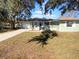 Charming single-story home boasts a fresh, light green exterior with white trim and a neatly manicured front yard at 14912 Sw 35Th Cir, Ocala, FL 34473