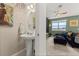 Stylish bathroom with a pedestal sink and a view of a living area at 161 Mandovi St, Davenport, FL 33837