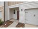 Townhouse front entry with brown door and attached garage at 161 Mandovi St, Davenport, FL 33837