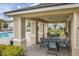 Covered patio area with tables and chairs near the pool at 161 Mandovi St, Davenport, FL 33837