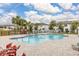 Community swimming pool with lounge chairs and surrounding landscaping at 161 Mandovi St, Davenport, FL 33837