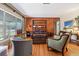 Hardwood floors and a wood paneled wall in living room at 1613 Oriole Ave, Orlando, FL 32803