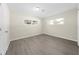 Well-lit bedroom, featuring wood-look floors and two windows at 16247 Lake Johns Cir, Winter Garden, FL 34787