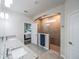 Modern bathroom with double vanity, granite countertop and a view into bedroom at 17791 Passionflower Cir, Clermont, FL 34714