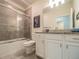 Bathroom with shower/tub combo and granite countertop at 17791 Passionflower Cir, Clermont, FL 34714