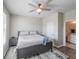 Spacious bedroom with king-size bed, ceiling fan, and access to a bathroom at 17791 Passionflower Cir, Clermont, FL 34714