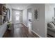 Inviting entryway with wood flooring, a decorative rug, and a view to the living area at 17791 Passionflower Cir, Clermont, FL 34714