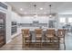 Modern kitchen with island, stainless steel appliances, and white cabinets at 17791 Passionflower Cir, Clermont, FL 34714