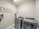 Laundry room with Whirlpool washer and dryer, and ample storage at 17791 Passionflower Cir, Clermont, FL 34714