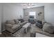 Cozy living room featuring comfortable sofas, a coffee table, and a flat-screen TV at 17791 Passionflower Cir, Clermont, FL 34714