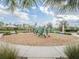 Modern playground with wood-chip surface and shaded seating at 17791 Passionflower Cir, Clermont, FL 34714