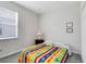 Inviting bedroom with a full-size bed and colorful bedding at 2340 Grasmere View S Pkwy, Kissimmee, FL 34746