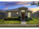 One-story home with a brown door and well-manicured lawn at 2340 Grasmere View S Pkwy, Kissimmee, FL 34746