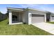 Attached garage with covered patio and lush lawn at 2340 Grasmere View S Pkwy, Kissimmee, FL 34746